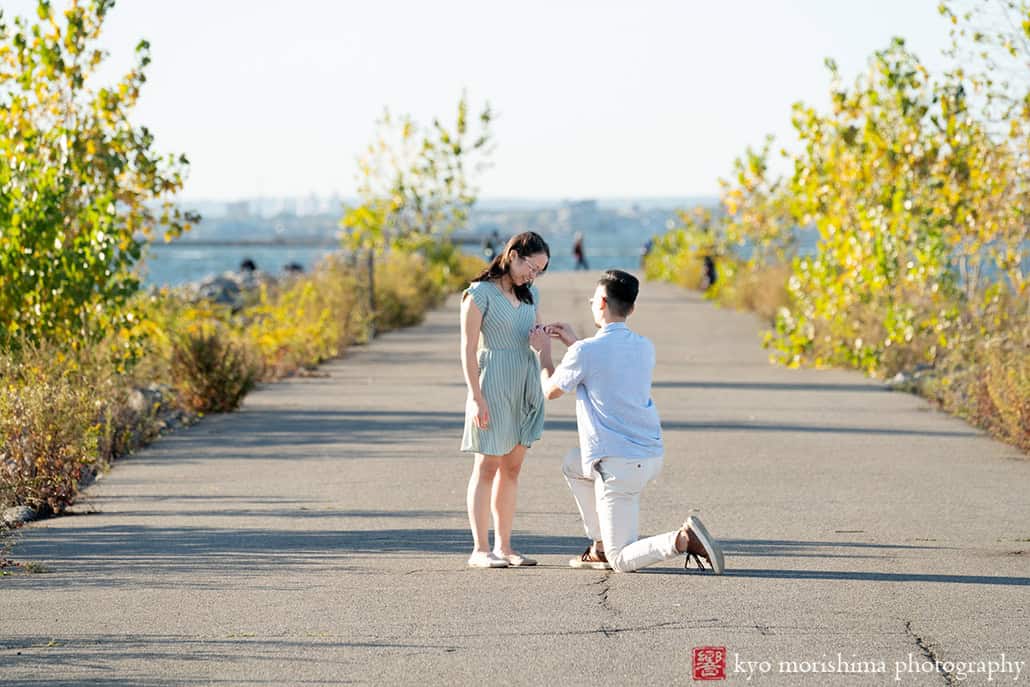 Scavenger Hunt proposal engagement couple portrait Bush Terminal Piers Park Brooklyn NYC down on his knee