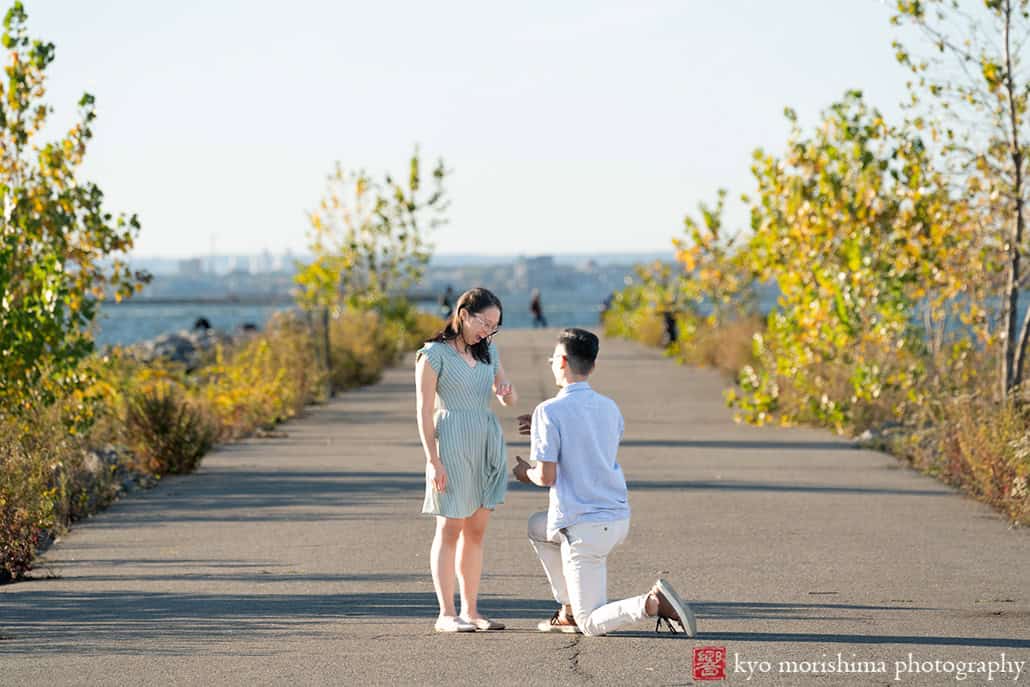 Scavenger Hunt proposal engagement couple portrait Bush Terminal Piers Park Brooklyn NYC down on his knee