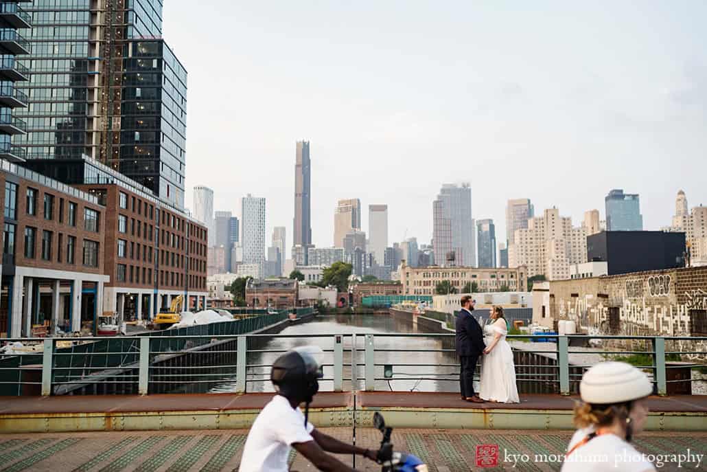 501 Union Gowanus canal Brooklyn documentary street life style wedding portrait bride and groom holding hands bikers passing by