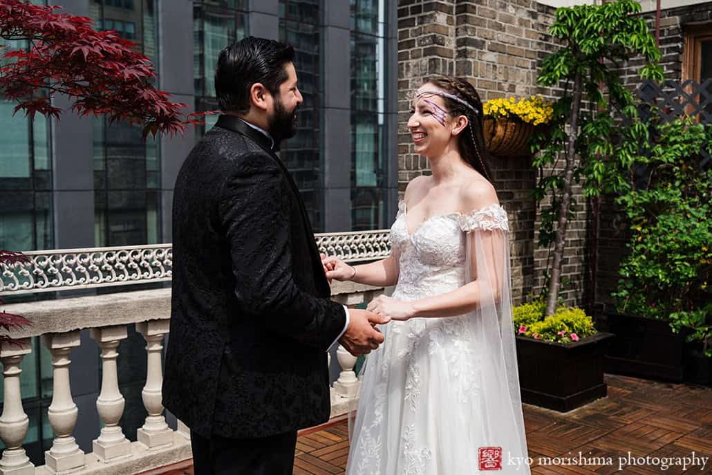 Bride and groom outdoor first look with Empire State Building at Midtown Loft & Terrac, Manhattan NYC rooftop wedding event venue holding hands