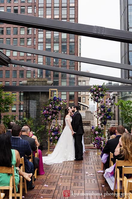 Bride and groom Outdoor ceremony Midtown Loft & Terrac, Manhattan NYC rooftop wedding kiss