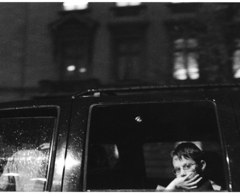 street photography decisive moment, black and white, film, snow day, Washington DC a boy in a car