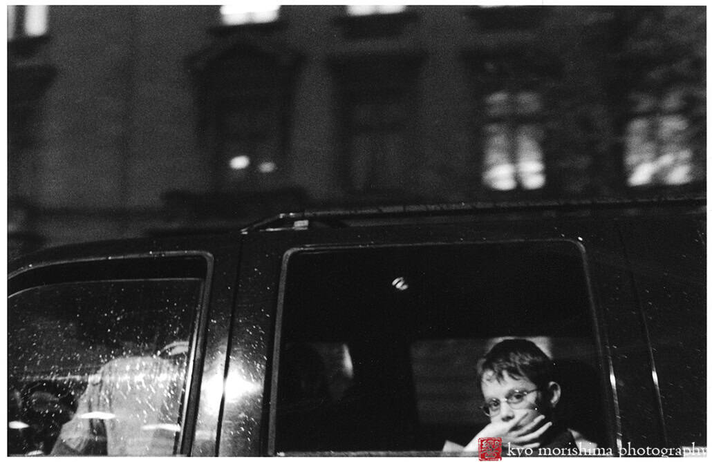 street photography decisive moment, black and white, film, snow day, Washington DC a boy in a car