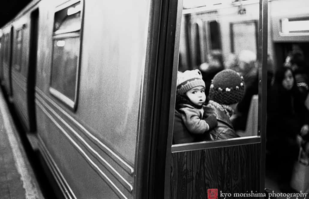 Baby on Parent’s Back in the NYC Subway