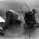 street photography decisive moment, black and white, film, man looking manhole midtown nyc