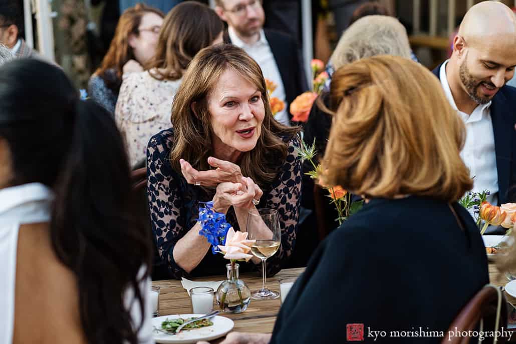 Roberta's Pizza, Brooklyn, Bushwick, NYC restaurant backyard wedding reception Kyo guests having fun smiling at table