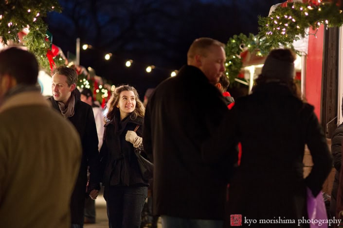 Holding hands together at a holiday market string lights at dusk Central Park NYC