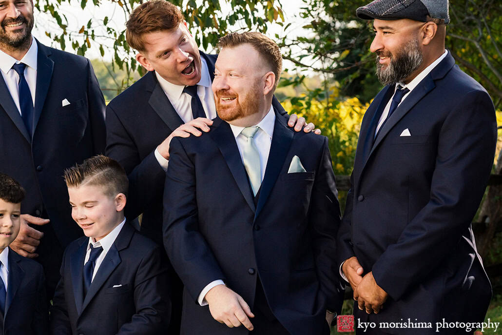 outdoor groom and groomsmen having fun portrait session field Princeton NJ Updike Farmstead summer fall autumn Wedding