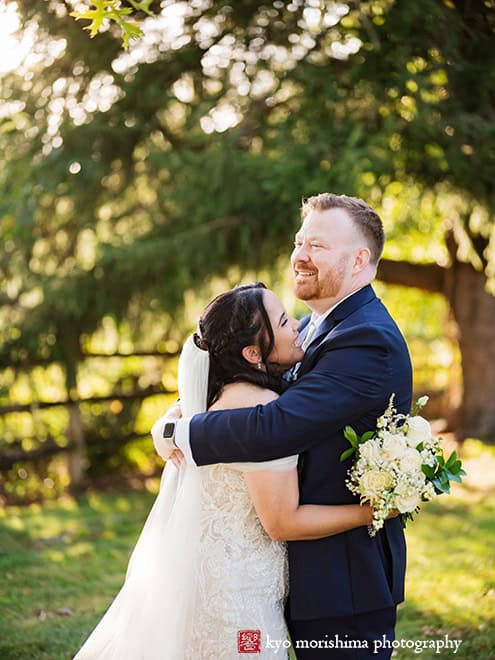 outdoor portrait bride and groom newlyweds holding hands tree field, Princeton NJ Updike Farmstead summer fall autumn Wedding hug laughing