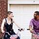 Governor's Island couple editorial street portrait engagement NYC lovers cycling dating smiling laughing looking at each other