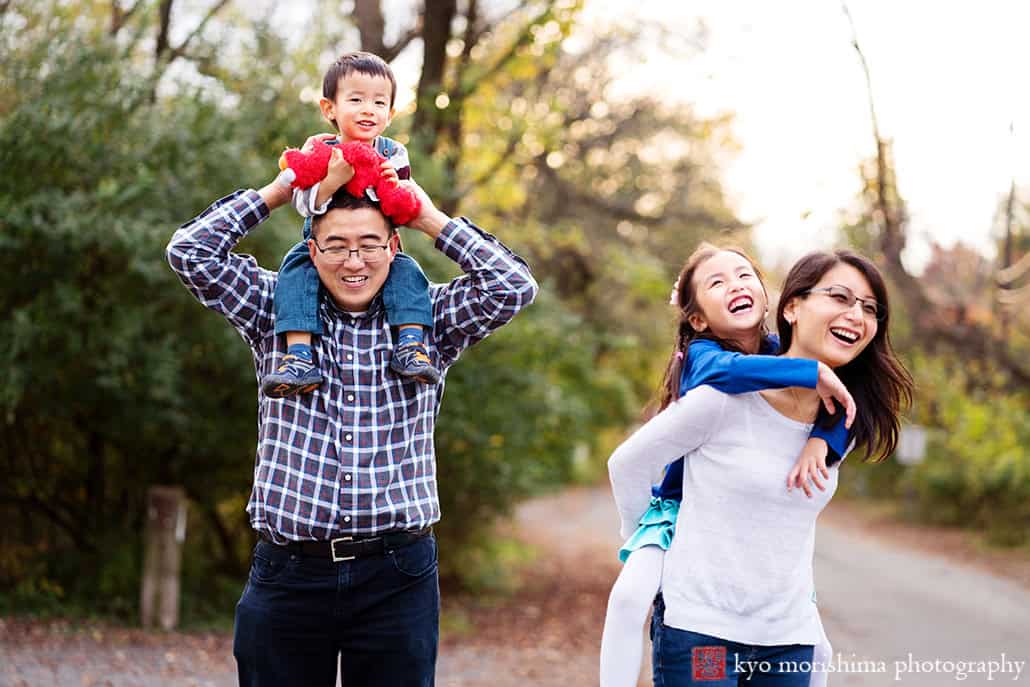 Children shoulder piggy back on parents playing outside d&r park Kingston New Jersey fall family photo