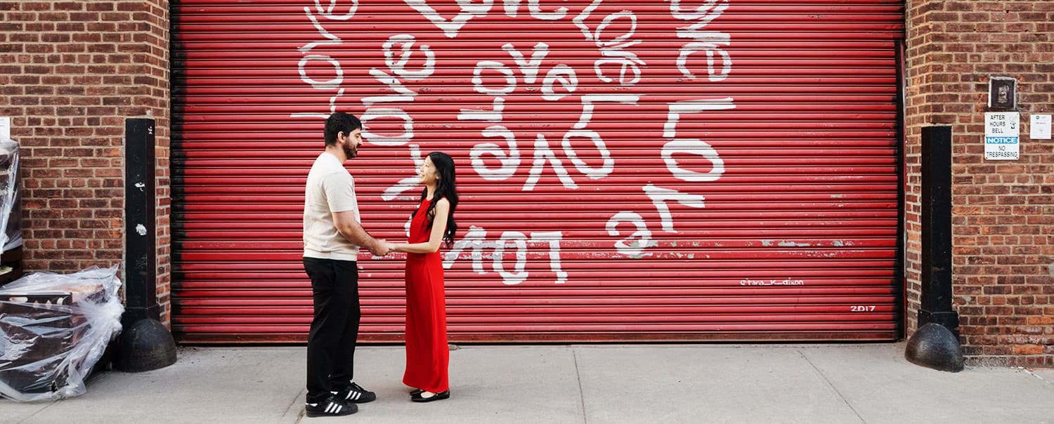 Brooklyn Dumbo NYC Vinegar Hill House couple street portraits holding hands love sign garage door