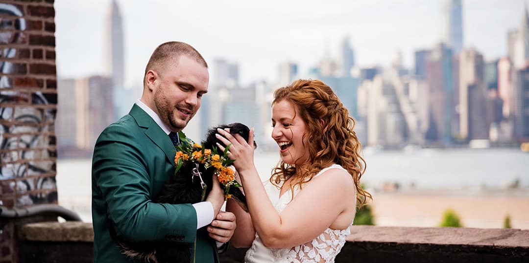 Greenpoint Loft Brooklyn NYC wedding bride and groom first look on balcony with a pet dog flower smile Manhattan skyscrapers