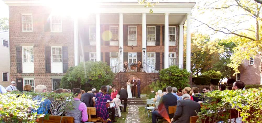 Bride and groom grin at end of Admiral's House Governors Island wedding ceremony photographed by Kyo Morishima