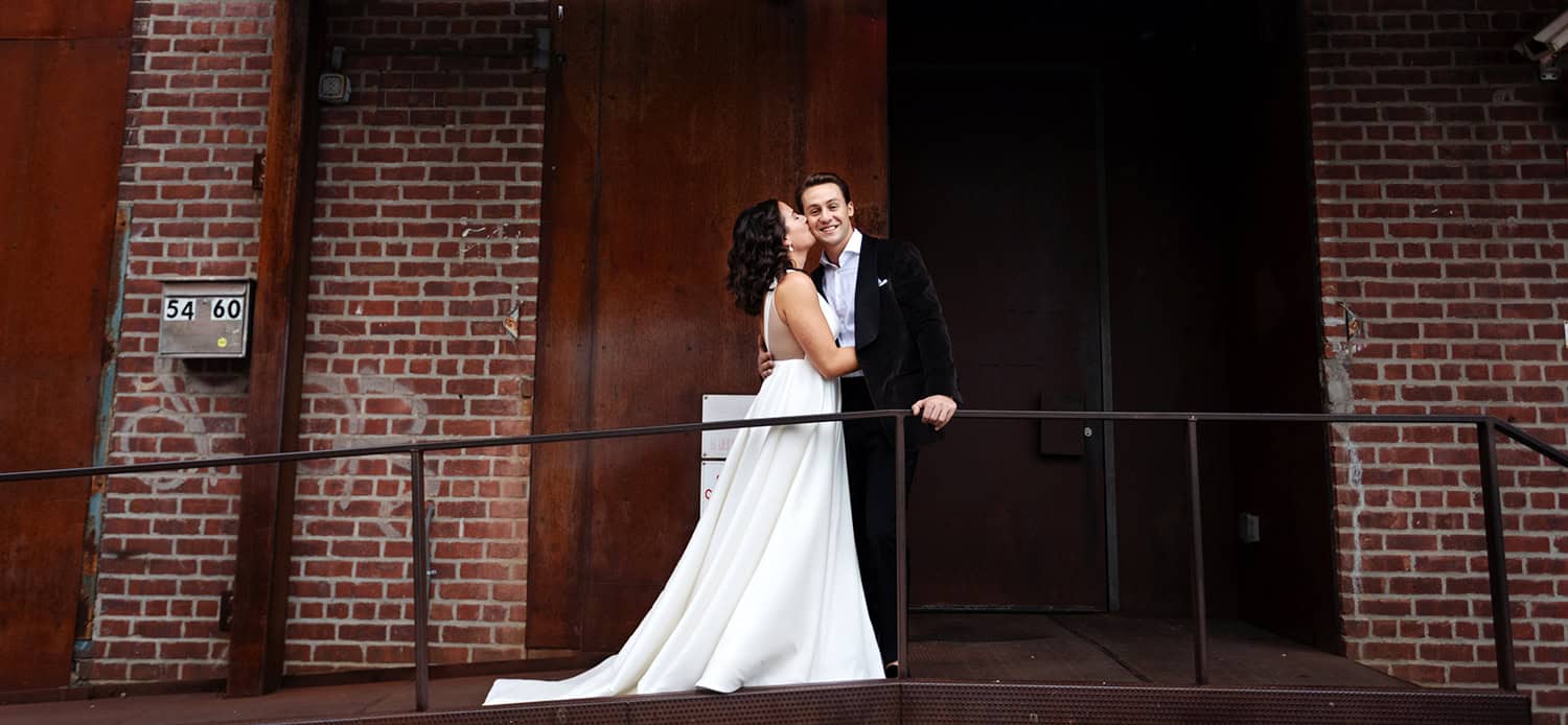 Bride kissed groom in front of Wythe Hotel Brooklyn wedding portrait